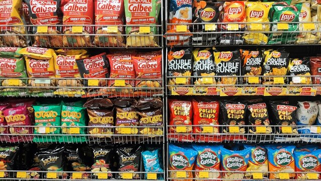 Malaysia, Kuala Terengganu 22 January 2026: Snacks in a supermarket. Colorful snack aisle in a supermarket, displaying a wide variety of chips and crisps from popular brands