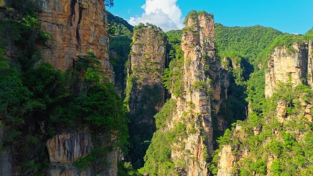 Aerial shot of the majestic sandstone pillars in Zhangjiajie National Forest Park, Hunan, China, on a clear sunny day.