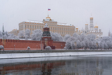 Grand Kremlin Palace, the Annunciation Tower and the ensemble of the Kremlin Cathedral Square from the embankment of the Moskva River in heavy snowfall, Moscow, Russia