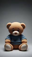 Obraz premium Cute Teddy Bear Doll Sitting Down in Blue Sweater