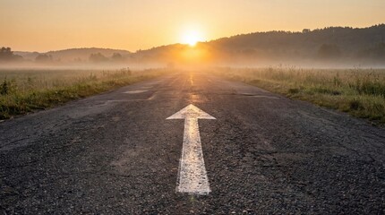 white arrow sign asphalt road with rising sun background