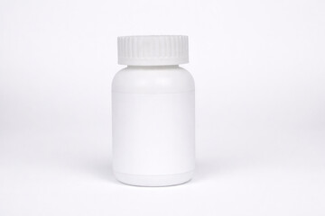 White blank plastic pill bottle with screw cap isolated on clean white background. Pharmaceutical container mockup for medicine, supplements, vitamins, healthcare products, and packaging design.