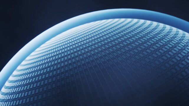 Close up blue glow on rotating semiconductor wafer displaying microchip grid pattern and advanced computation technology