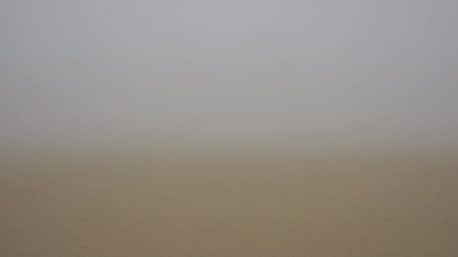 Blurry hazy landscape with light gradations, earth tones, and muted sky