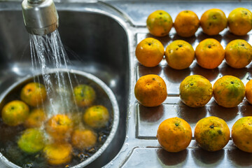 Closeup of orange fruit on kitchen sink