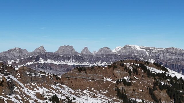 Aerial panoramic view of the Churfirsten mountain range above Flumserberg near Lake Walensee in eastern Swiss Alps.