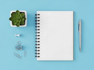 A notebook and stationery items arranged neatly on a blue background viewed from directly above
