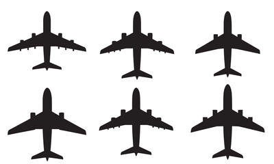 Set of six black silhouettes of passenger jet airplanes from a top-down perspective.