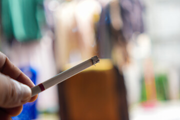a lit cigarette in the hand ready to be smoked © arif