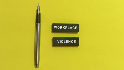 Conceptual image highlighting workplace violence with text blocks and a pen, advocating for safety, justice, and respect in professional environments