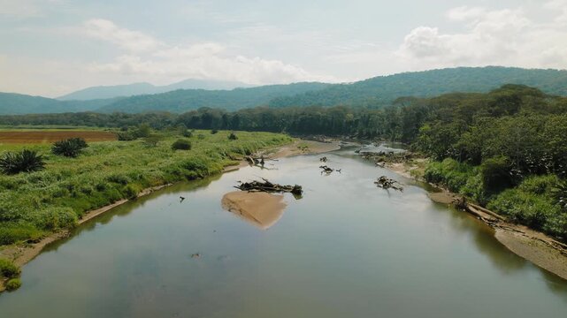 Scenic drone view of Tarcoles River and green mountains in rural Costa Rica