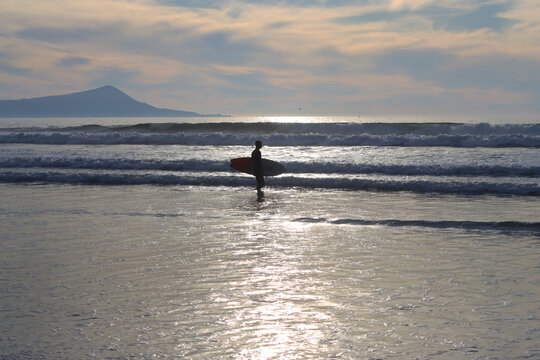 Surfer on the beach. Ensenada, Mexico.
