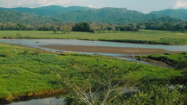 Scenic river valley surrounded by green mountains in Tarcoles Costa Rica