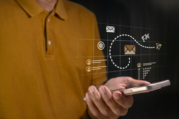 A man using a smartphone to promote a product or service on a website, email, and social media. Digital marketing concept.