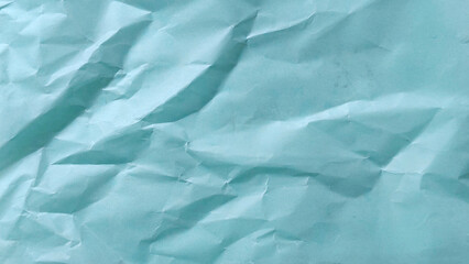Obraz premium Crumpled light blue paper texture background with abstract folds and creative wrinkles