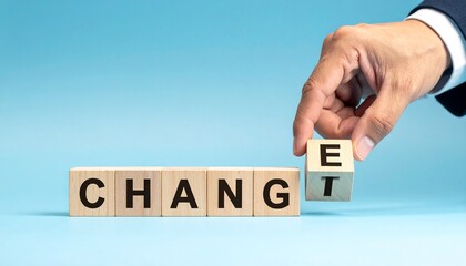 Hand adding T block to CHANGE word