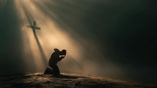 Kneeling man praying dramatic sunlight with cross shadow and golden light, solitude and devotion misty forest, kneeling person bathed golden light with cross shaped shadow conveying spiritual