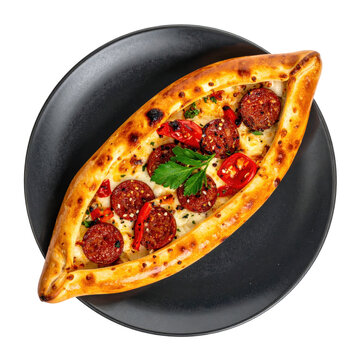 Aromatic sucuk pide presented on a dark surface, highlighting the generous sausage coverage isolated on white background