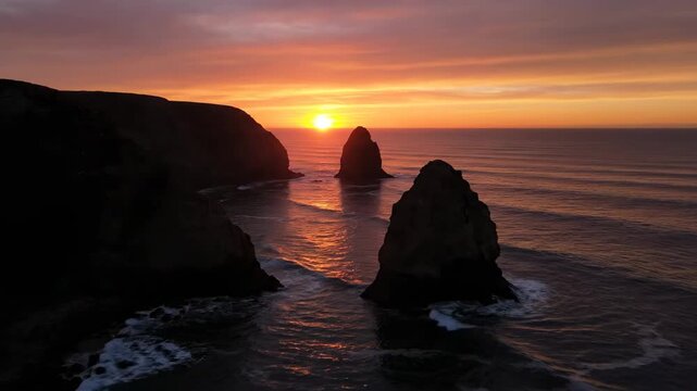 A breathtaking seascape at sunrise with sea stacks and dark cliffs