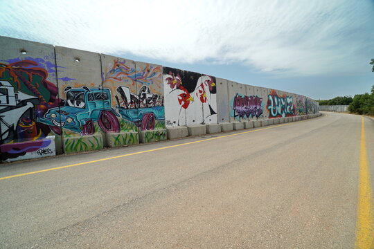 border wall of Israel and Lebanon with graffiti  of peace and co existence on the Israeli side near the settlement of Shtula 