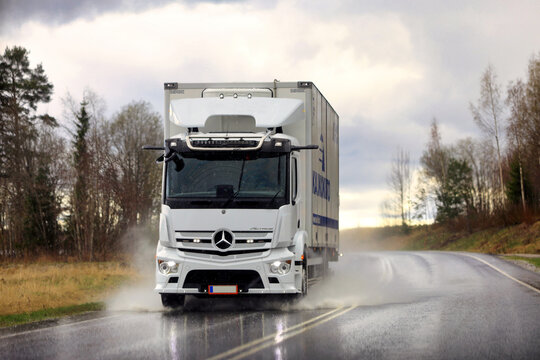 Road Transport by a White Mercedes-Benz Freight Truck on a Rainy Day. 