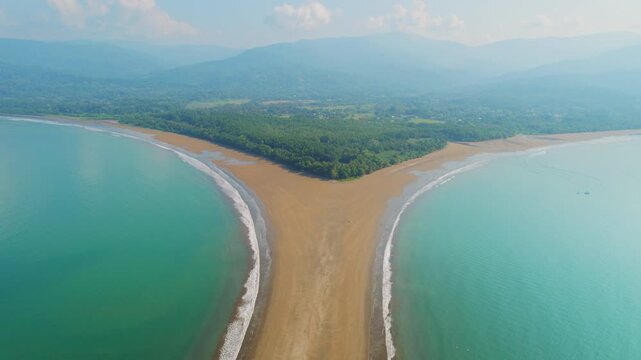 Ocean and unique sandbar tombolo formation at Marino Ballena National Park in Costa Rica