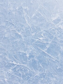 Scratched ice texture surface with heavy skate marks on a blue rink for winter sports and seasonal recreation background with copy space for frosty graphic design