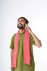 young indian farmer talking on smartphone standing on white background