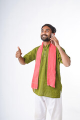 young indian farmer talking on smartphone standing on white background