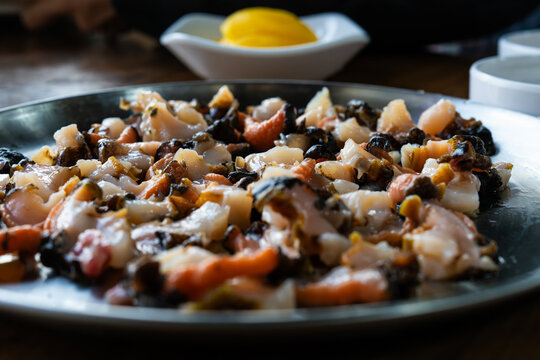 close-up of fresh conch sashimi slices on a dish