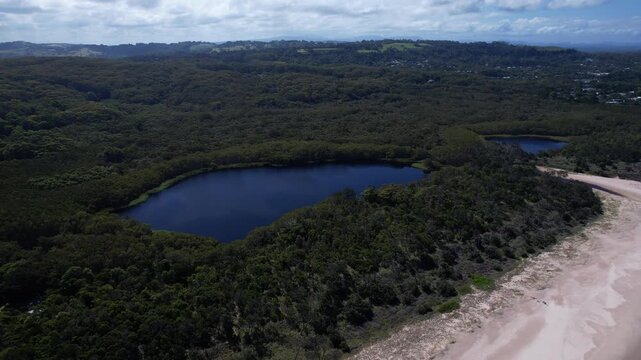 Aerial View of Tallow Creek, Broken Head Beach, Tea Tree Lake, Deep Blue Ocean and Lush Forest, NSW, Australia &ndash; Drone Shot