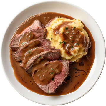 Sliced roast beef with gravy served alongside creamy mashed potatoes on a plate isolated on white background