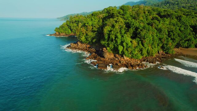 Green tropical forest meets rocky coastline at Hermosa Beach Costa Rica