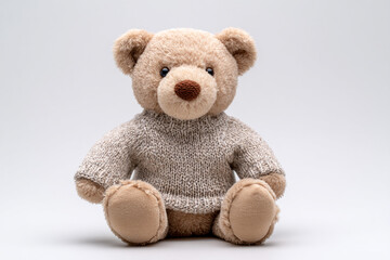 Obraz premium Adorable teddy bear wearing a cozy sweater, perfect for children's products, heartwarming campaigns, and creating a sense of comfort and nostalgia
