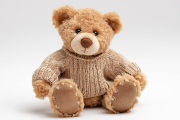Obraz premium Adorable teddy bear wearing a cozy sweater, perfect for children's products, childhood memories, and heartwarming designs, bringing joy.