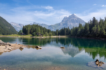 Arni lake reflecting mountains and forest in Gurtnellen, Uri