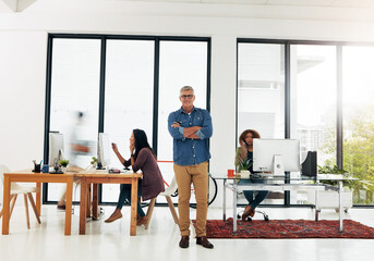 Fototapeta premium Portrait, entrepreneur and man with arms crossed in busy office, confident and web design business. Professional, pride and happy manager of company in workplace, startup and agency development