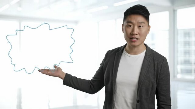 A professional, ethnically ambiguous individual in a charcoal blazer and white shirt gestures confidently against a minimalist studio background, presenting a concept for business communication