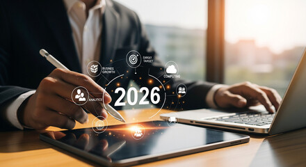 Business growth strategy 2026, businessman using digital tablet with holographic icons for target and cloud computing
