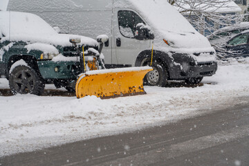 truck with snowplow installed on the driveway