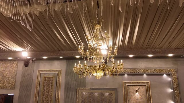 Aerial Drone View of Luxury Wedding Marquee Ceiling with Golden Chandelier, royal and sophisticated wedding atmosphere, perfect for luxury wedding visuals and interior decor promotions.