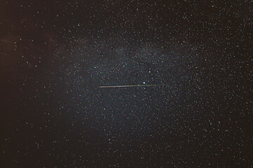 Fototapeta premium Real Night Sky Stars With Milky Way Galaxy. Natural Starry Sky Background with meteor trails lights. Background Night Starry Sky With Bright Stars And Meteoric Track Trail