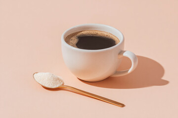 Coffee cup with spoon of powdered colostrum supplement on pastel background for wellness trend