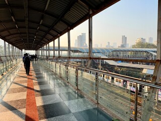 Urban railway scene showing informal settlement and social contrast in Mumbai India
