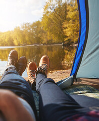 Couple, shoes and tent by lake for camping, morning and legs or boots with view in nature. Man,...