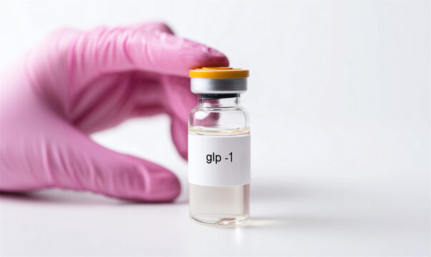 healthcare professional wearing a pink protective glove holding a glp-1 medication vial symbolizing advances in diabetes management. Weight loss treatments and modern metabolic healthcare solutions