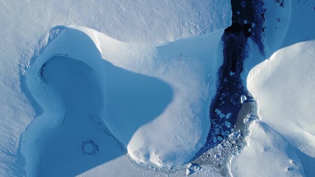 Aerial view of a beautiful iceberg on a sunny day in Antarctica