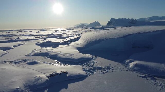 Aerial view of a beautiful iceberg on a sunny day in Antarctica
