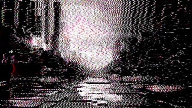 Heavily distorted and glitched image of a dark urban street with intense static interference and digital noise, creating an abstract, unsettling visual.