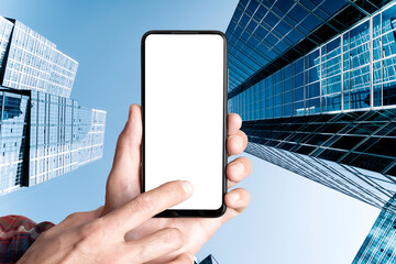 Mobile Phone Screen Mockup Held in Hand Against Towering Downtown Skyscrapers